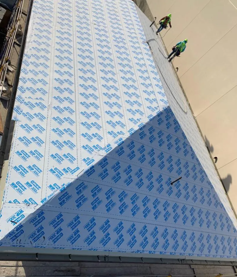 Professional roofers installing underlayment on a metal roof in Dunn Loring